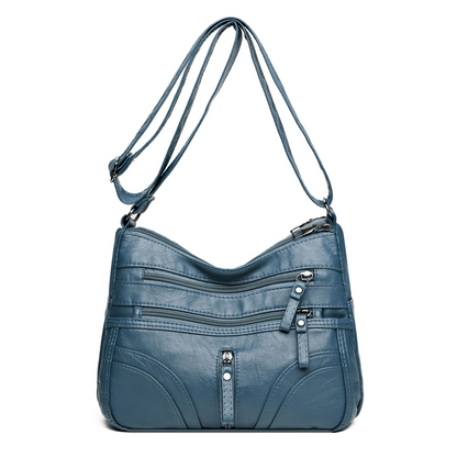 Bolso bandolera elegante con cremallera y detalles femeninos