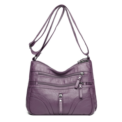 Bolso bandolera elegante con cremallera y detalles femeninos