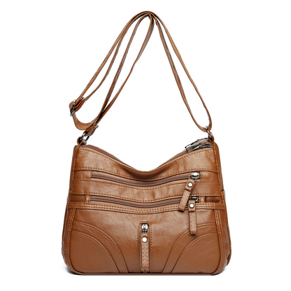 Bolso bandolera elegante con cremallera y detalles femeninos